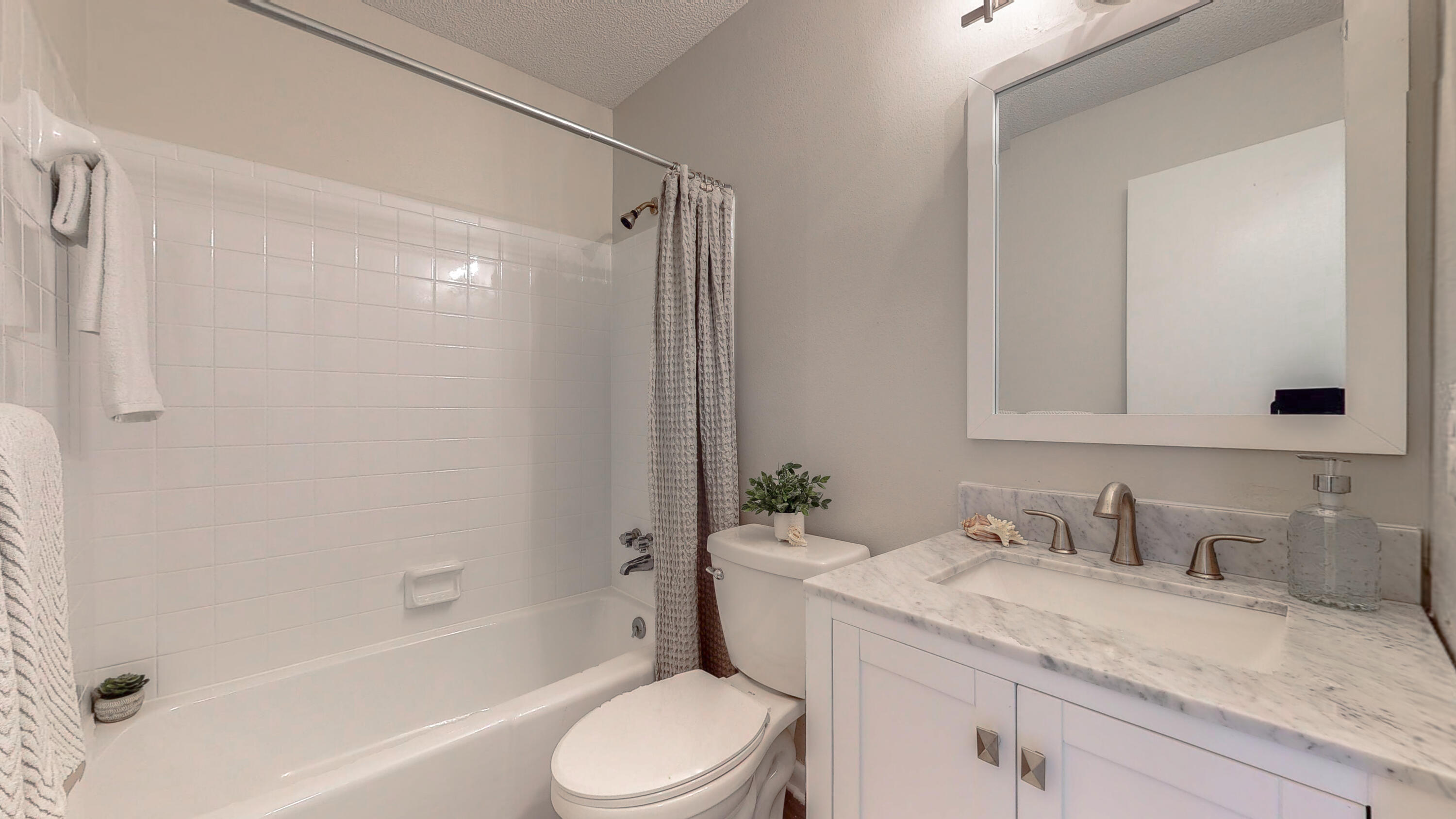 321 Echo Circle Fort Walton Beach, FL 32548 - Photo 12 of 35 a bathroom with a granite countertop sink toilet and shower