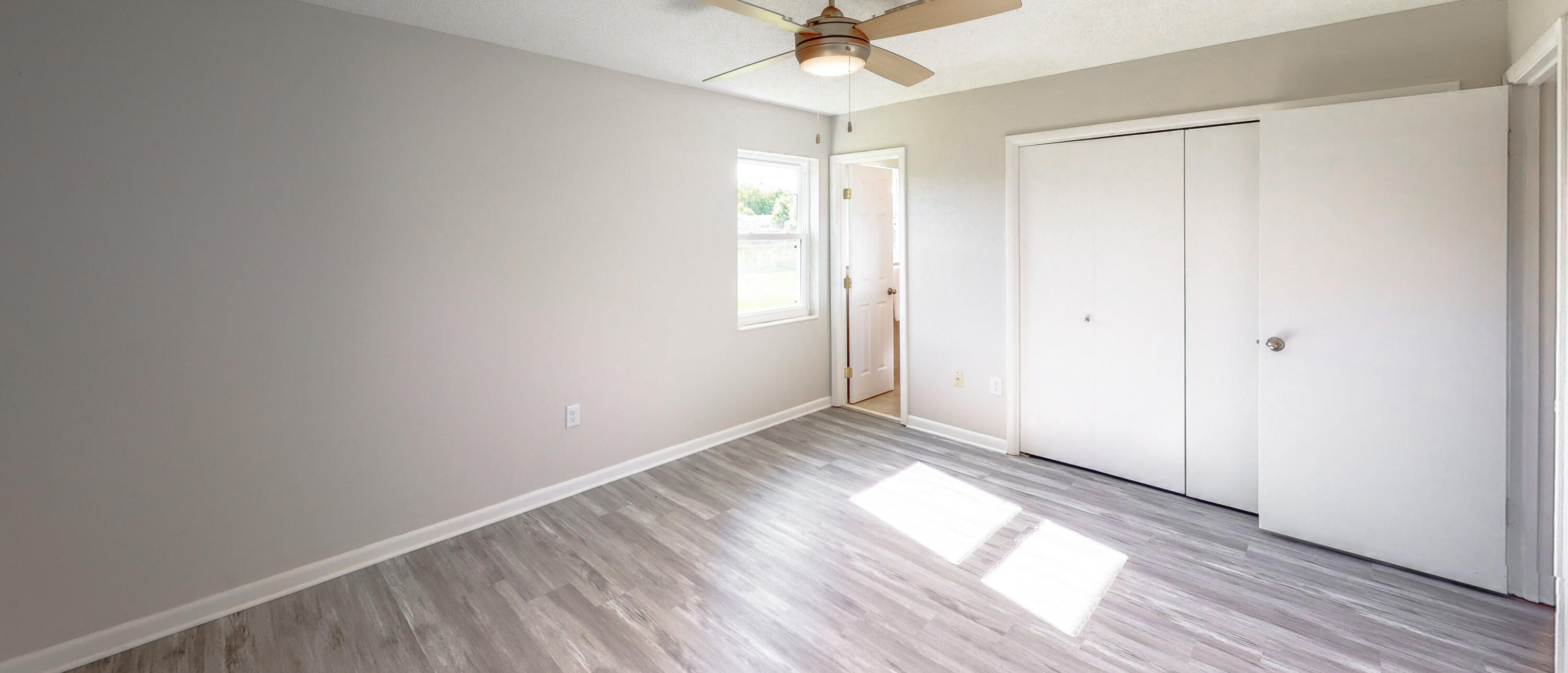 321 Echo Circle Fort Walton Beach, FL 32548 - Photo 19 of 35 wooden floor in an empty room with a window
