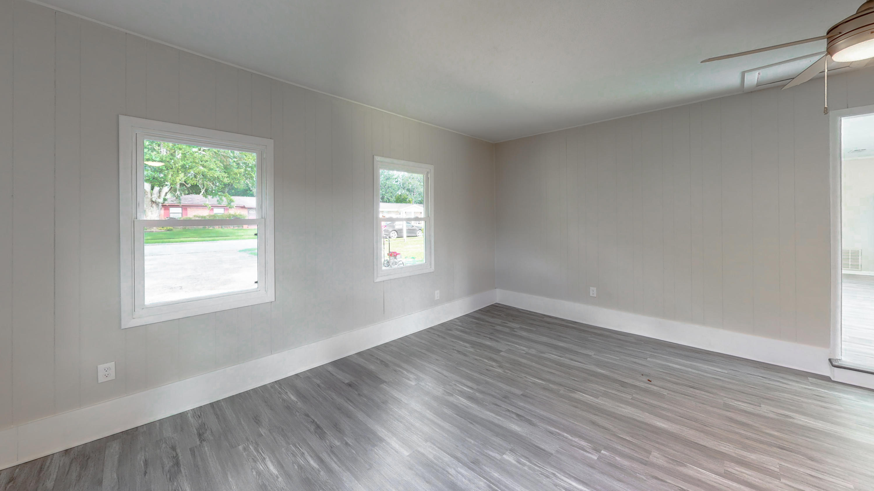 321 Echo Circle Fort Walton Beach, FL 32548 - Photo 25 of 35 a view of an empty room with wooden floor and a window