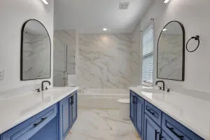 a bathroom with a double vanity sink and a mirror