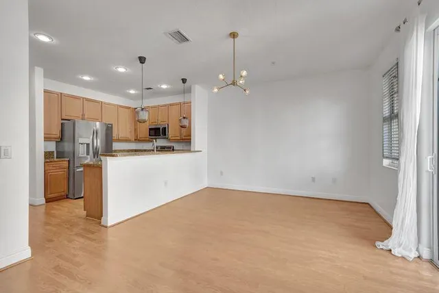 a view of kitchen with refrigerator and window