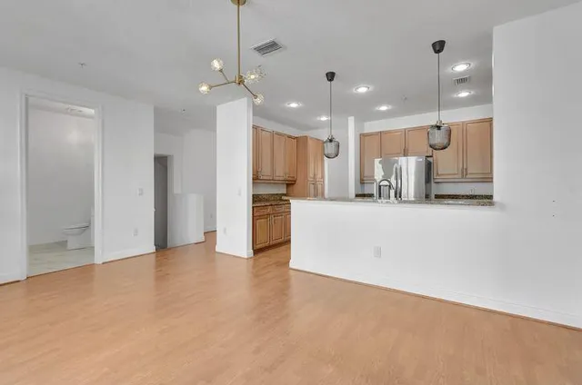 a view of a kitchen with a sink and a refrigerator