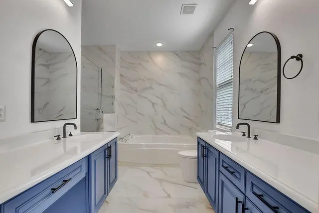 a bathroom with a double vanity sink and a mirror
