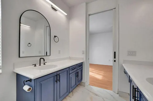 a bathroom with a sink and a mirror
