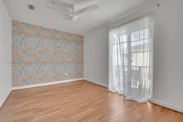 wooden floor in an empty room with a window