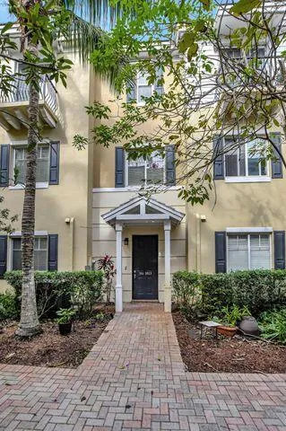 a front view of a house with yard and parking