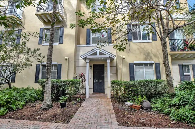 a front view of a house with yard and trees