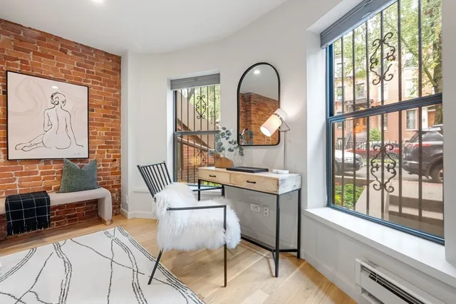 a living room with furniture a table and large windows