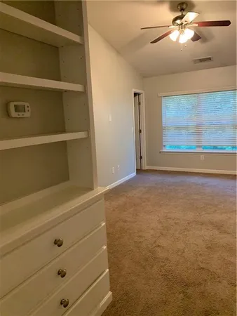 an empty room with windows and closet