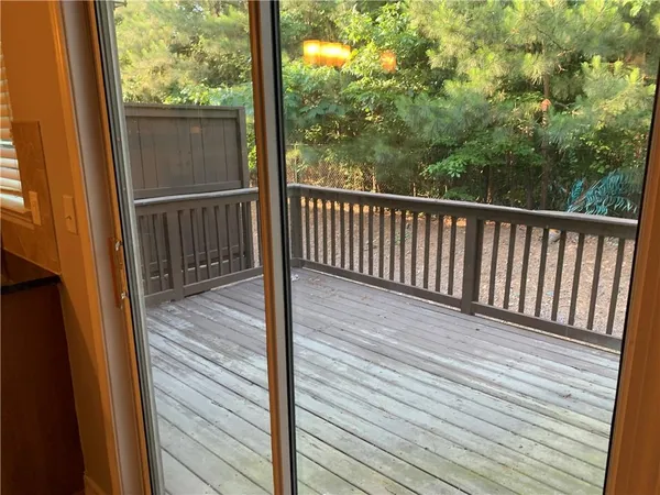 a view of a balcony with wooden floor