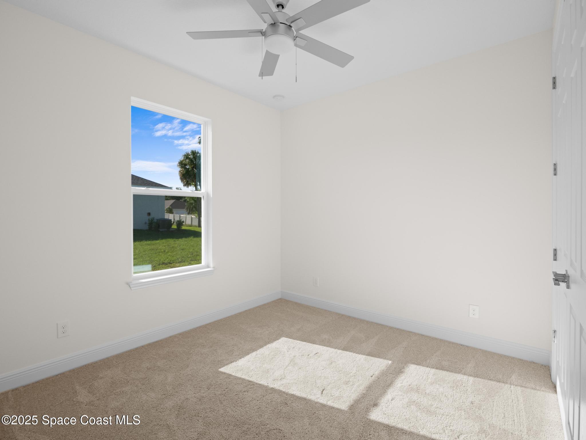 2112 Killian Drive Palm Bay, FL 32905 - Photo 16 of 19 an empty room with fan and windows