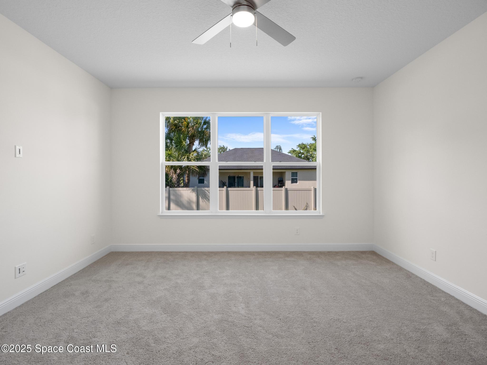 2112 Killian Drive Palm Bay, FL 32905 - Photo 3 of 19 an empty room with a window