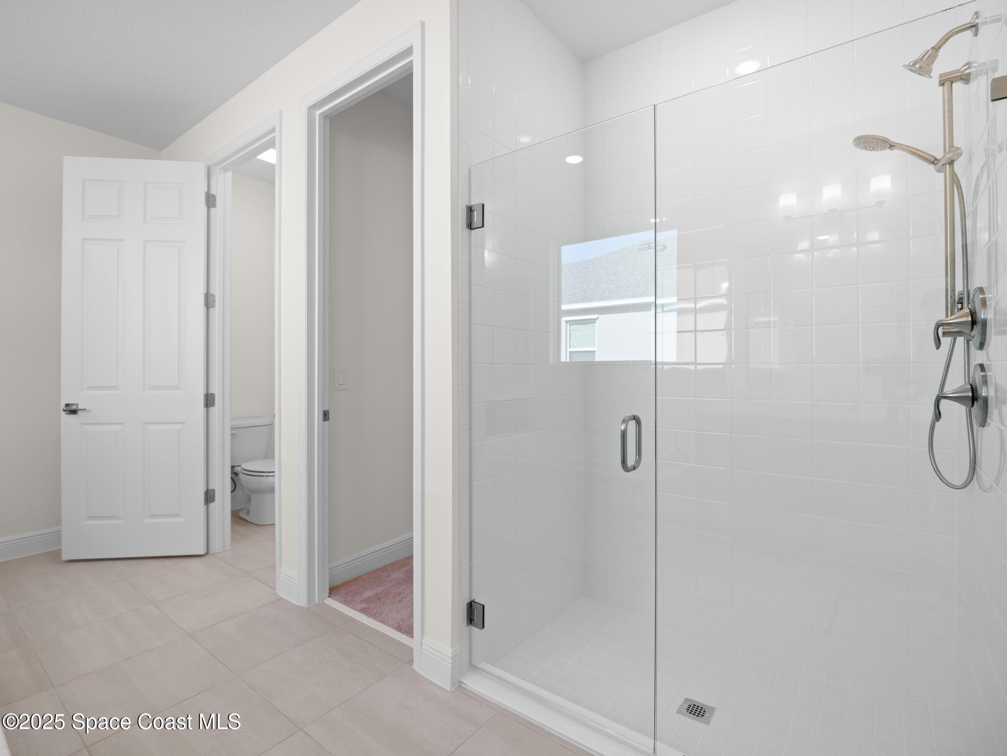 2112 Killian Drive Palm Bay, FL 32905 - Photo 5 of 19 a bathroom with a shower and a glass door