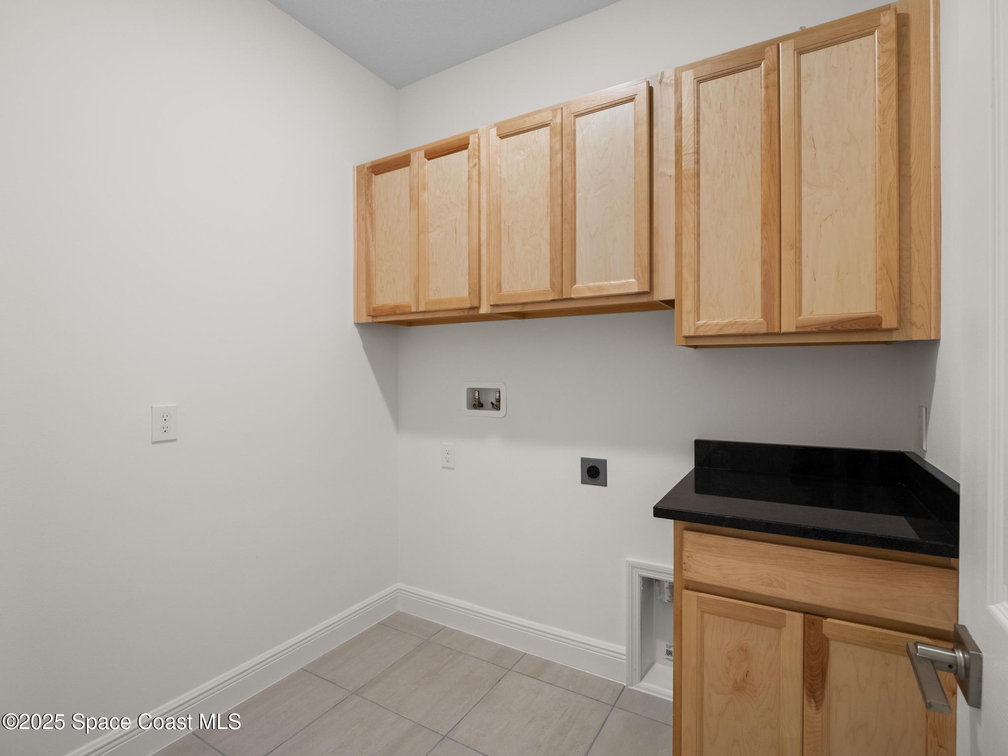 2112 Killian Drive Palm Bay, FL 32905 - Photo 9 of 19 a kitchen with a sink and cabinets