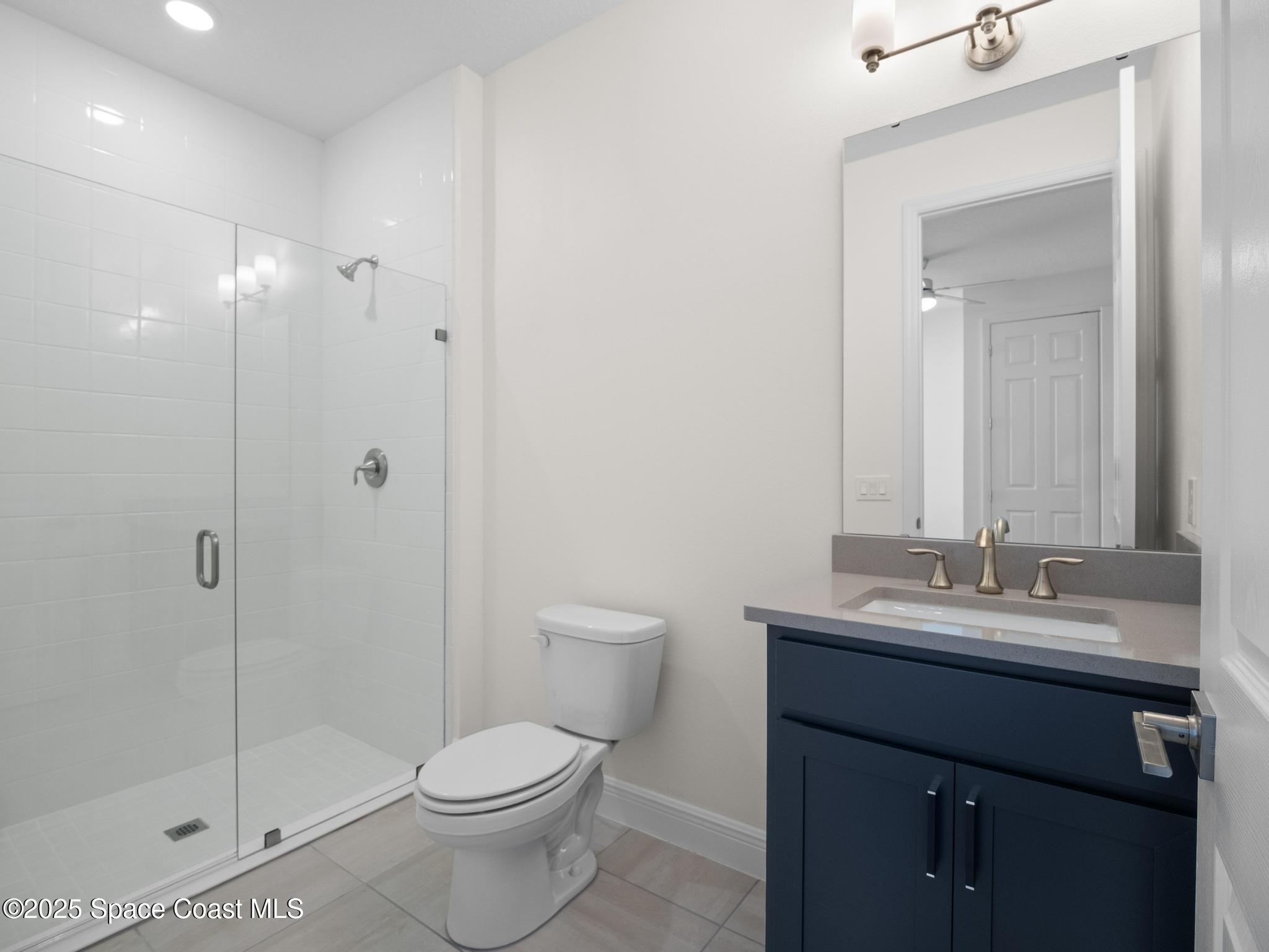 2112 Killian Drive Palm Bay, FL 32905 - Photo 10 of 19 a bathroom with a toilet a sink and shower