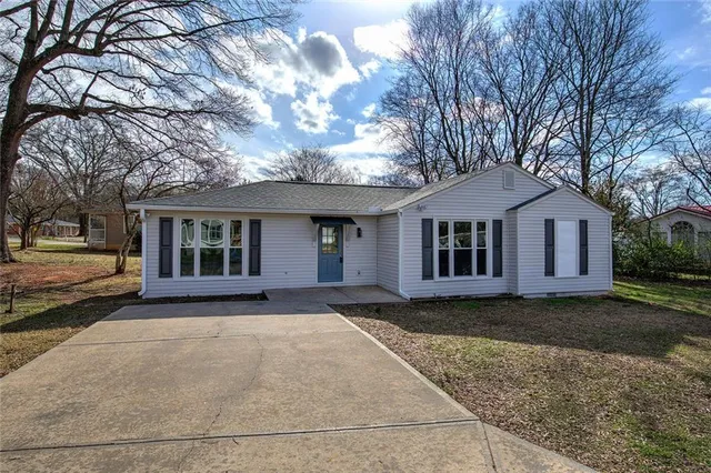 a front view of a house with a garden