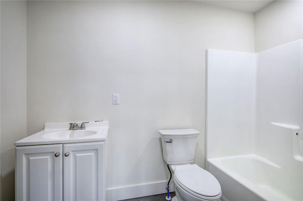 30 Grove Circle Cartersville, GA 30120 - Photo 26 of 33 a white toilet sitting next to a bathroom sink