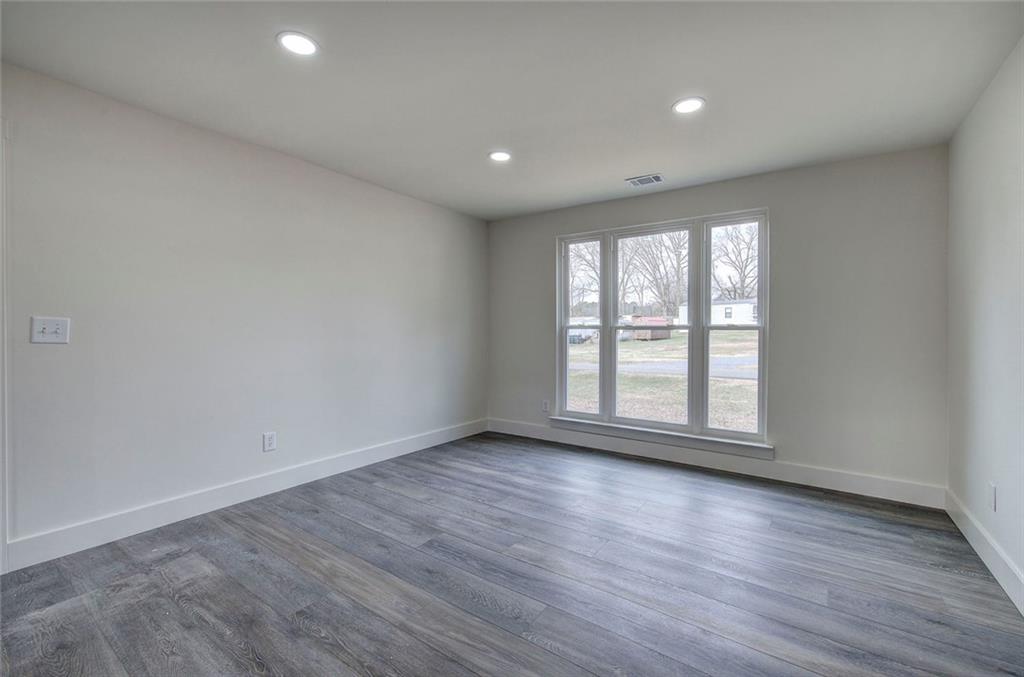 30 Grove Circle Cartersville, GA 30120 - Photo 8 of 33 a view of empty room with wooden floor and fan