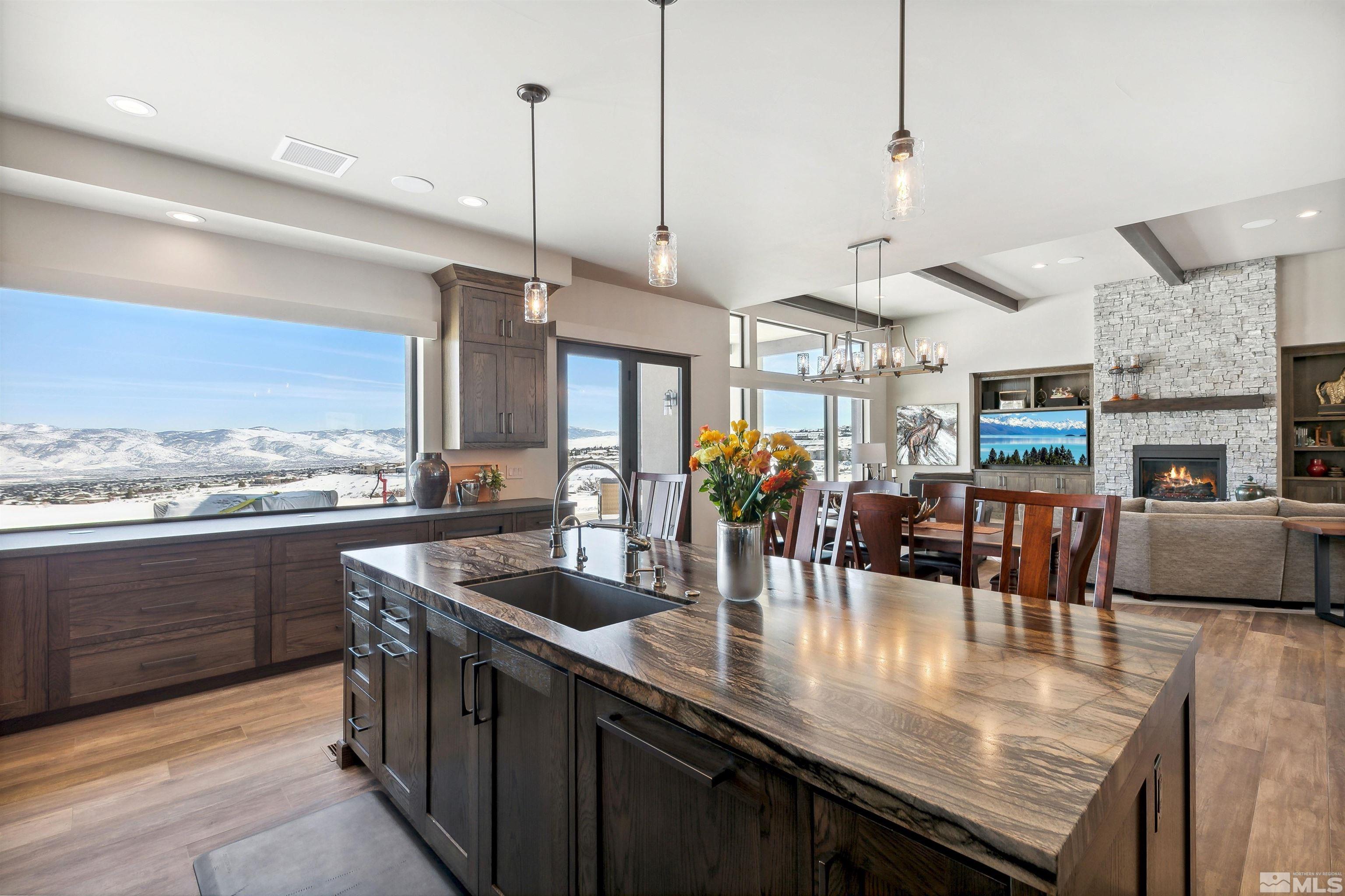 4110 Spotted Eagle Court Reno, NV 89511 - Photo 11 of 40 a kitchen with stainless steel appliances granite countertop a sink counter space and living room view