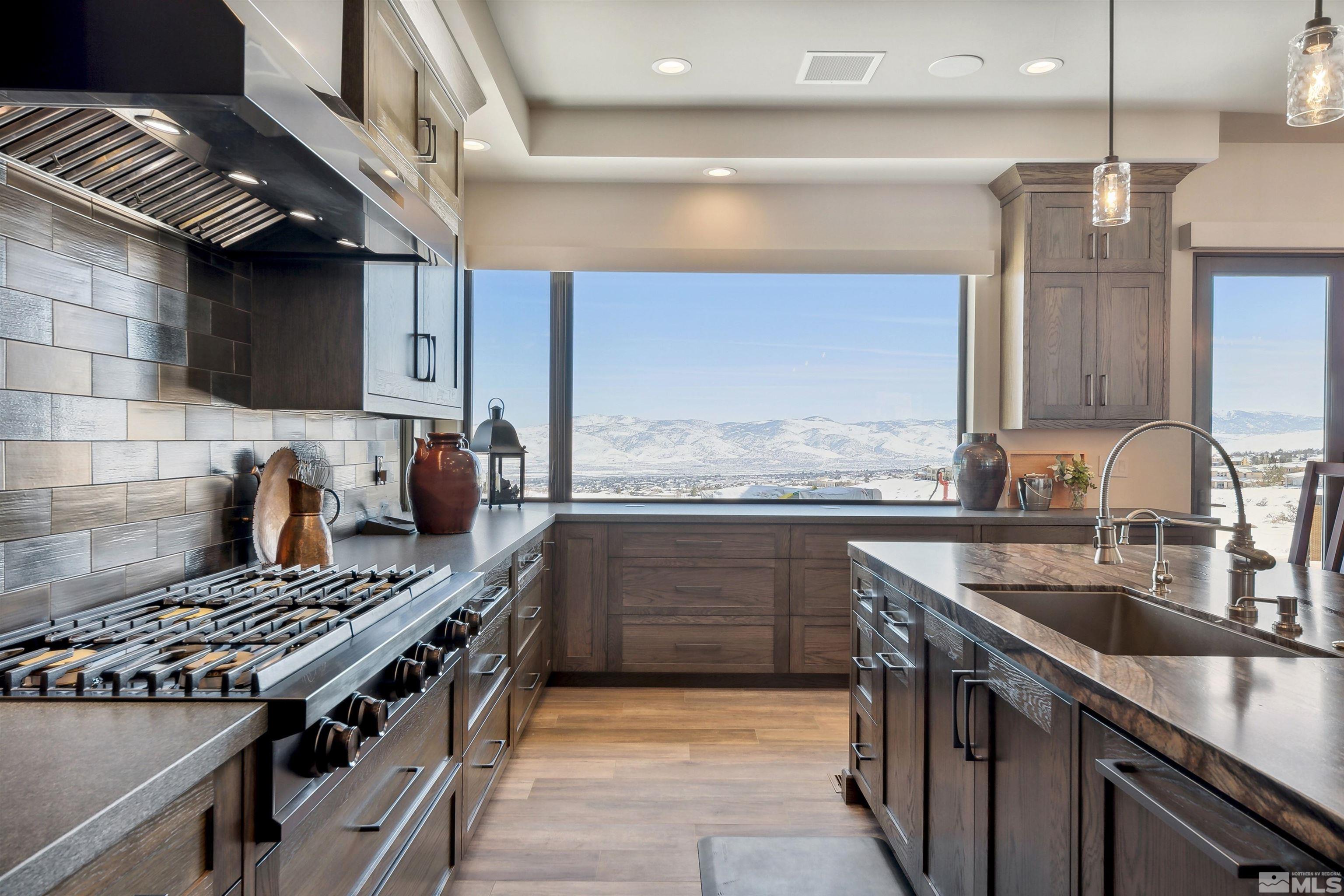 4110 Spotted Eagle Court Reno, NV 89511 - Photo 12 of 40 a kitchen with kitchen island granite countertop a sink stainless steel appliances and cabinets