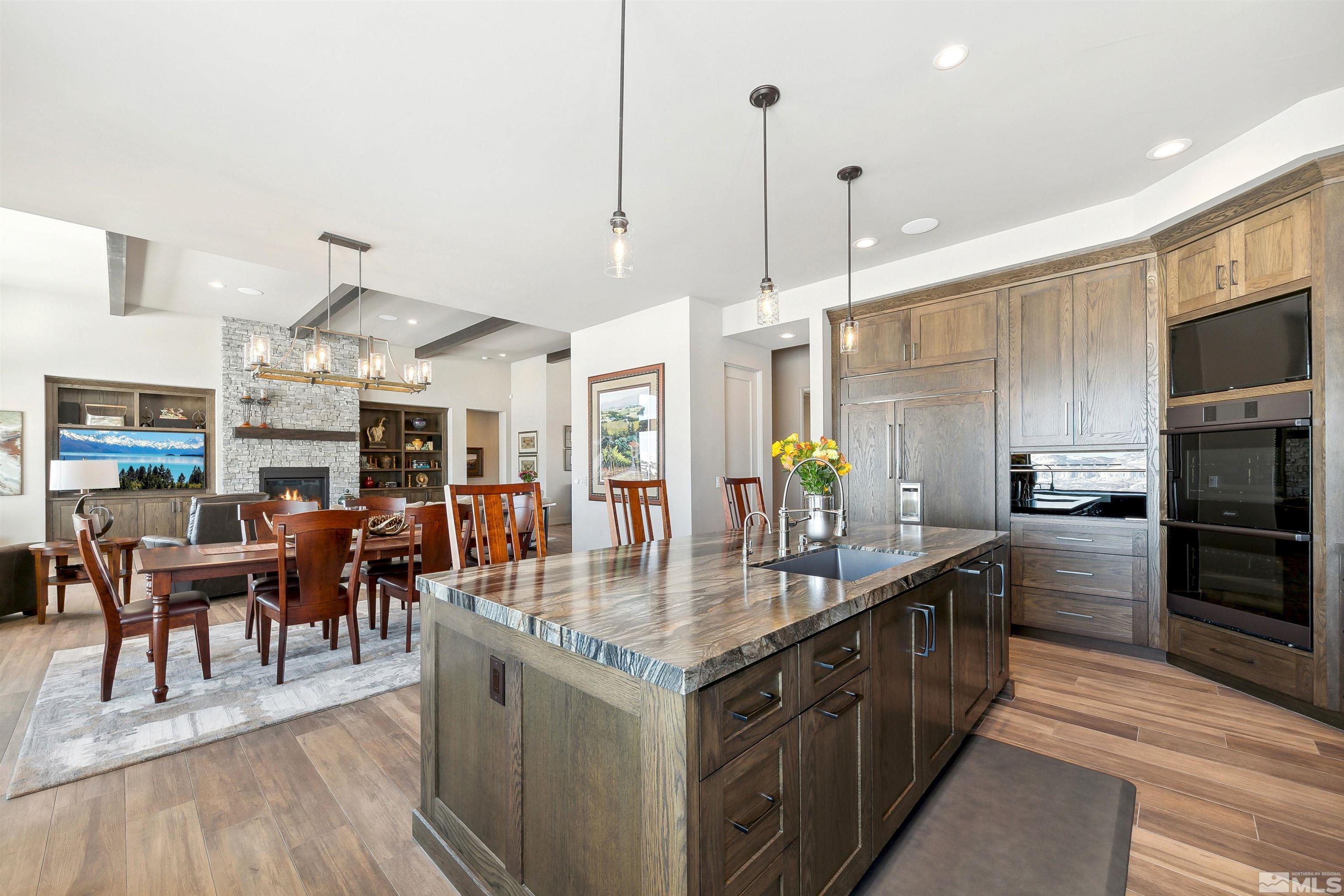 4110 Spotted Eagle Court Reno, NV 89511 - Photo 14 of 40 a kitchen with stainless steel appliances granite countertop a kitchen island a stove and a sink