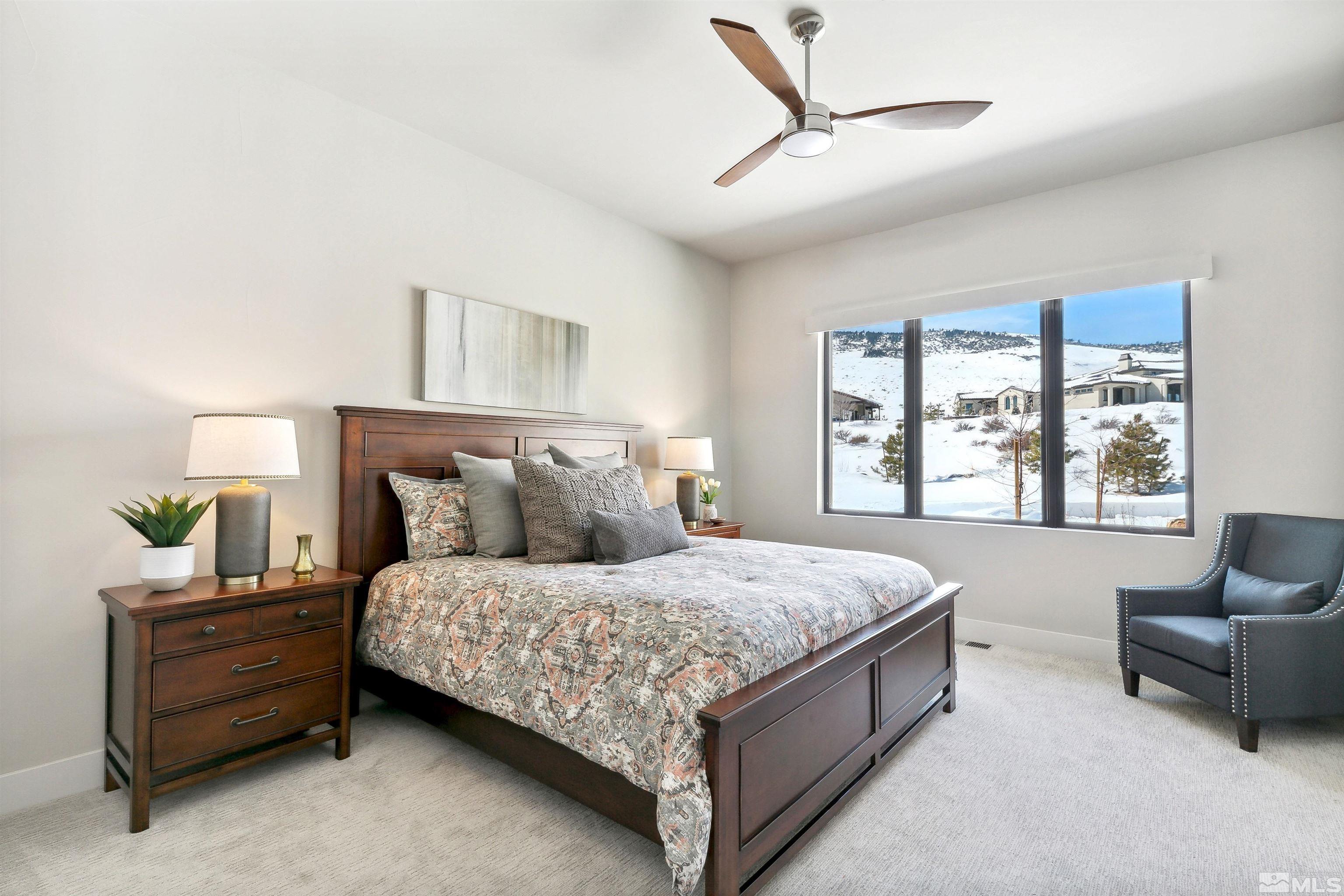 4110 Spotted Eagle Court Reno, NV 89511 - Photo 21 of 40 a bedroom with a bed couch and window