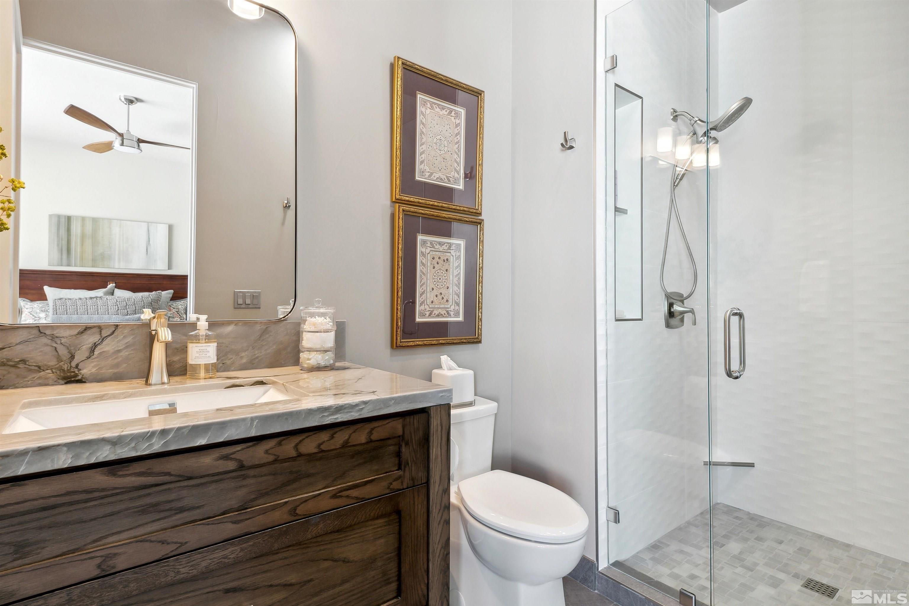 4110 Spotted Eagle Court Reno, NV 89511 - Photo 22 of 40 a bathroom with a granite countertop sink toilet and shower