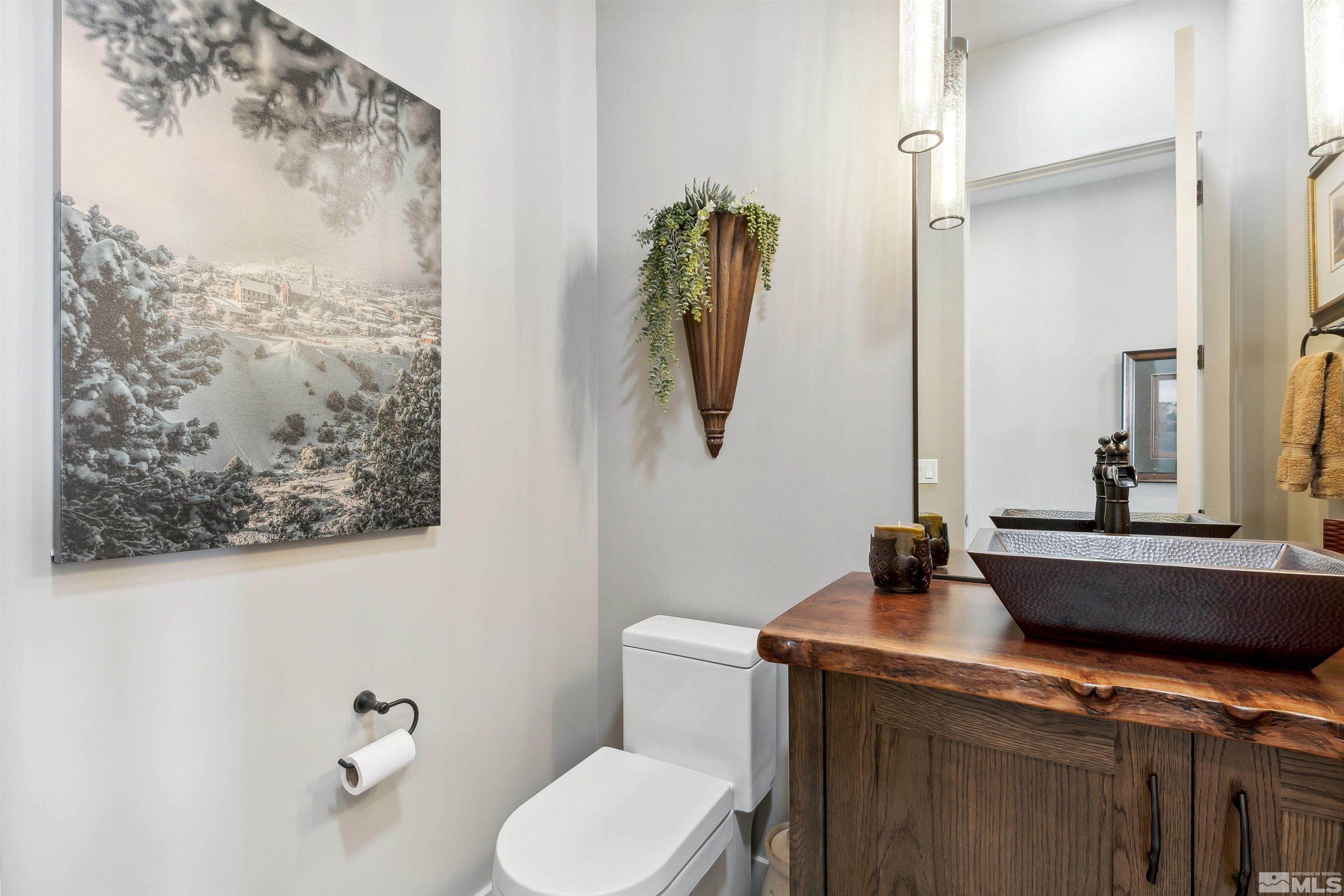 4110 Spotted Eagle Court Reno, NV 89511 - Photo 24 of 40 a bathroom with a granite countertop sink mirror and toilet