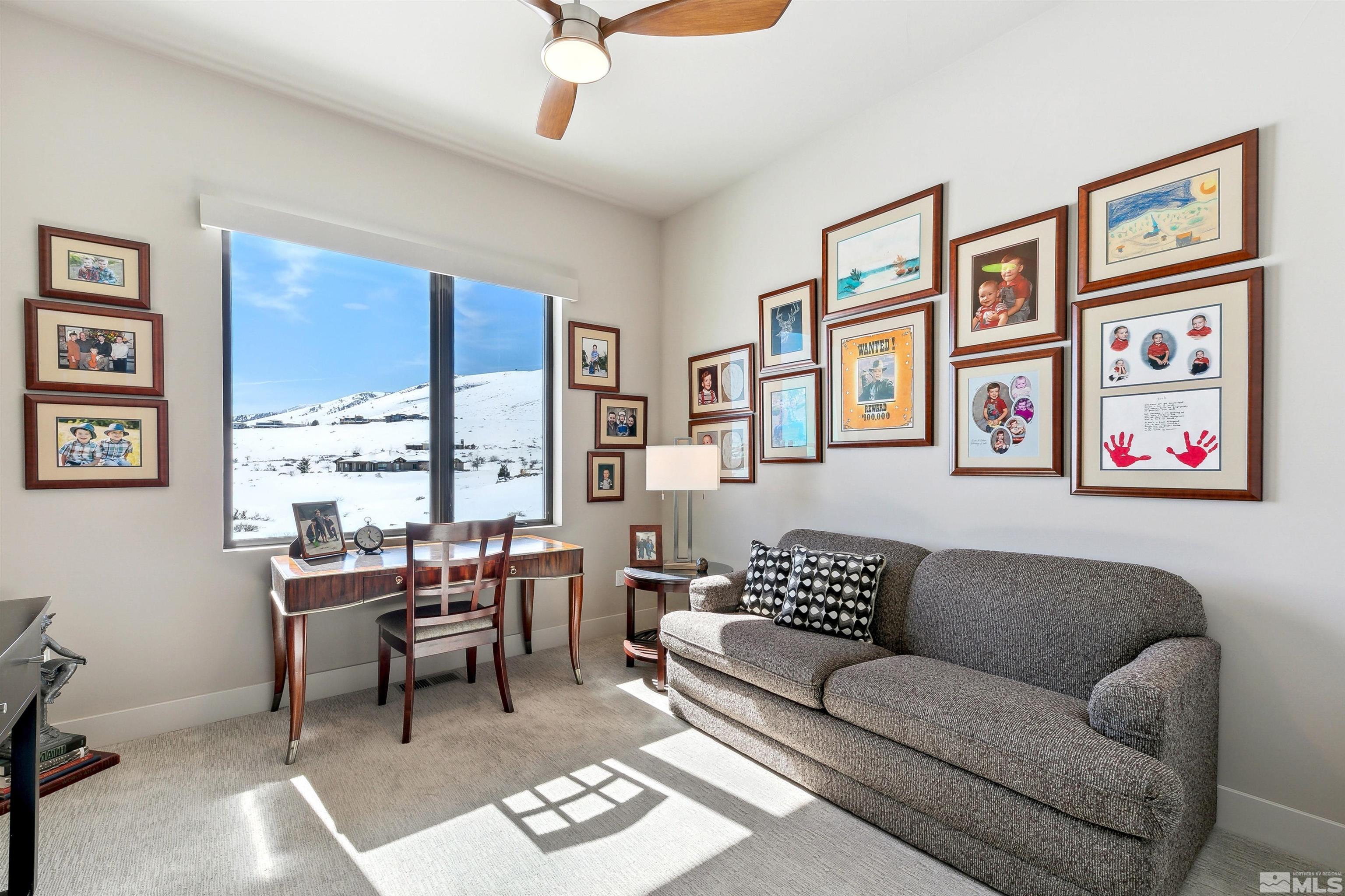 4110 Spotted Eagle Court Reno, NV 89511 - Photo 27 of 40 a living room with furniture ceiling fan and a large window