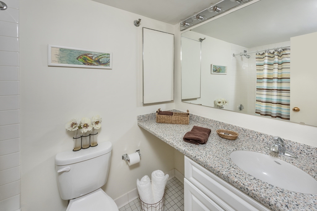 150 Huntington Avenue, Unit SJ3 Boston, MA 02115 - Photo 10 of 11 a bathroom with a granite countertop sink mirror and toilet