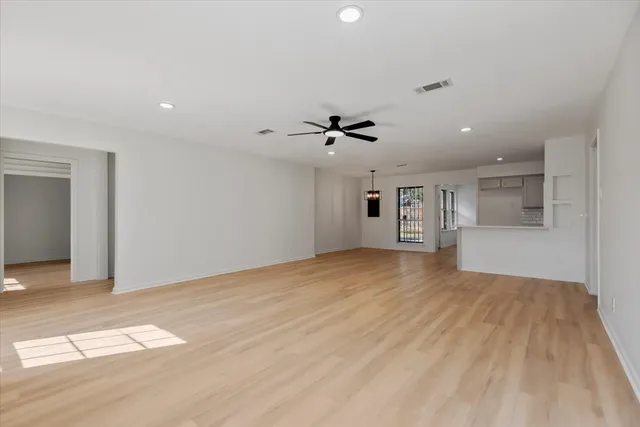 a view of a room with wooden floor and a window
