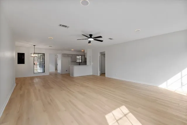a view of an empty room with a chandelier