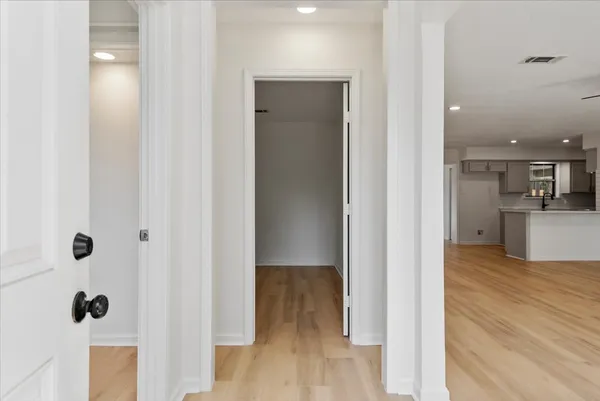 a view of a hallway with wooden floor