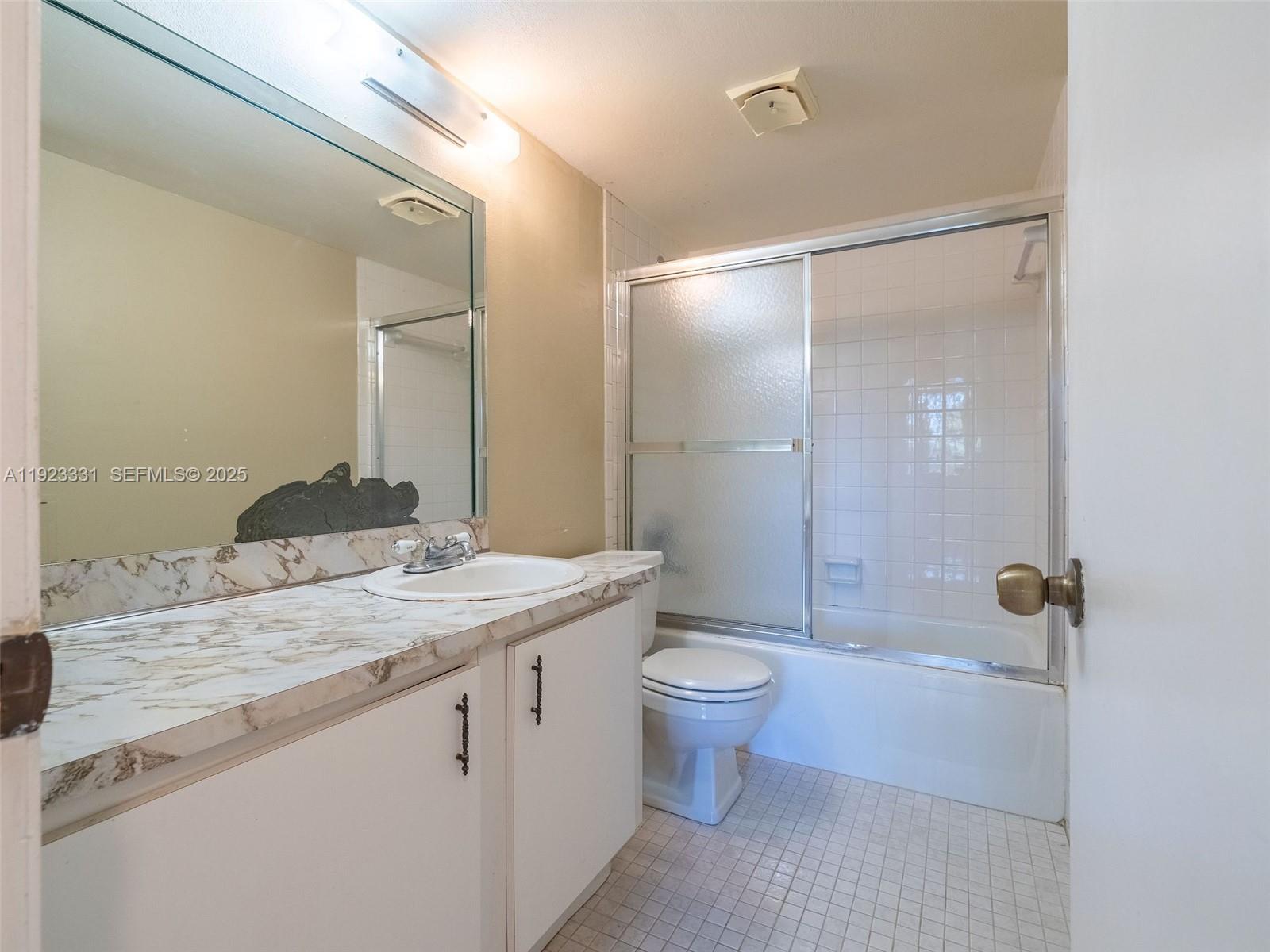 6600 Cypress Road, Unit 406 Plantation, FL 33317 - Photo 12 of 28 a bathroom with a granite countertop sink a toilet and shower