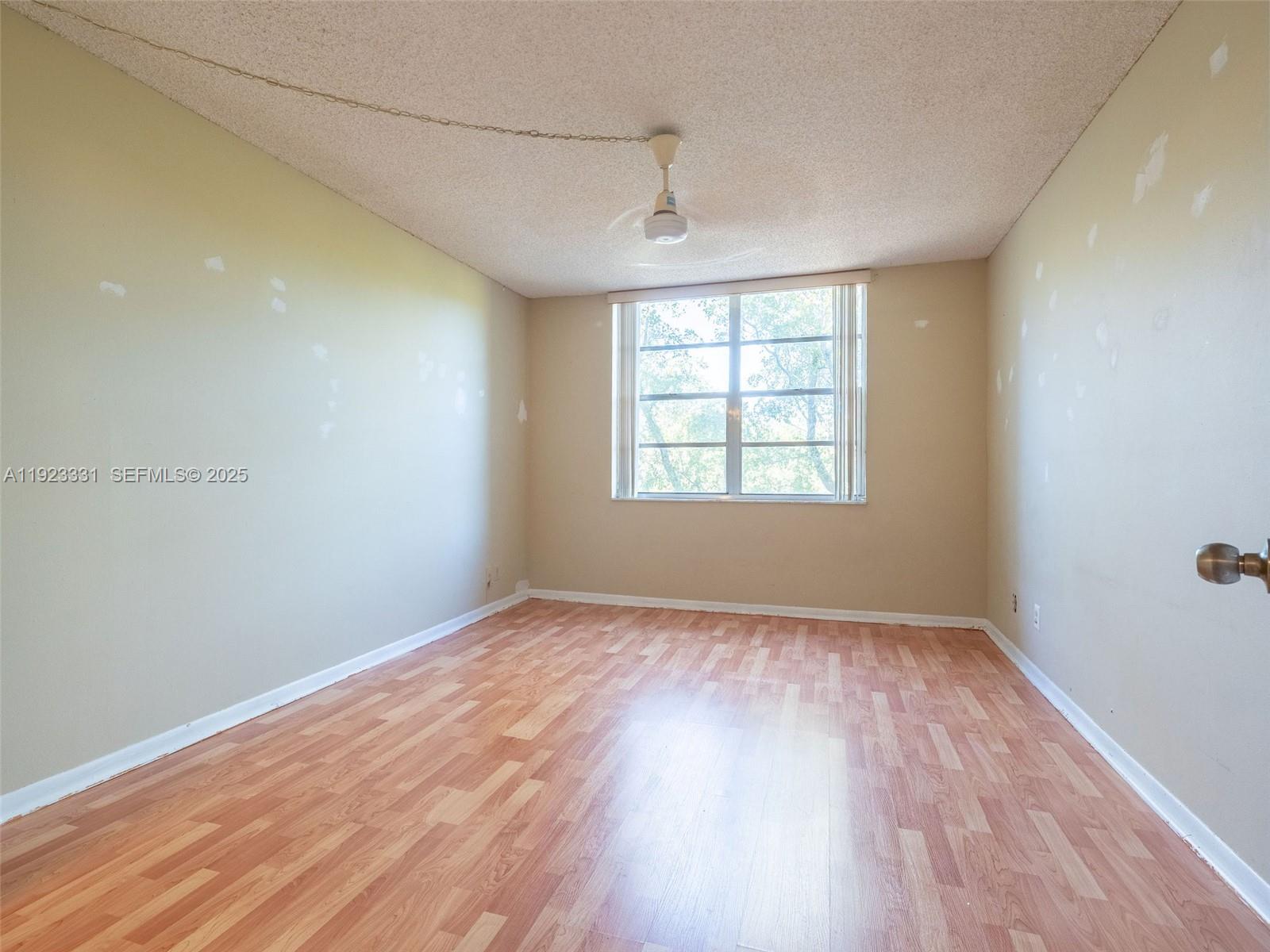 6600 Cypress Road, Unit 406 Plantation, FL 33317 - Photo 13 of 28 an empty room with wooden floor and windows