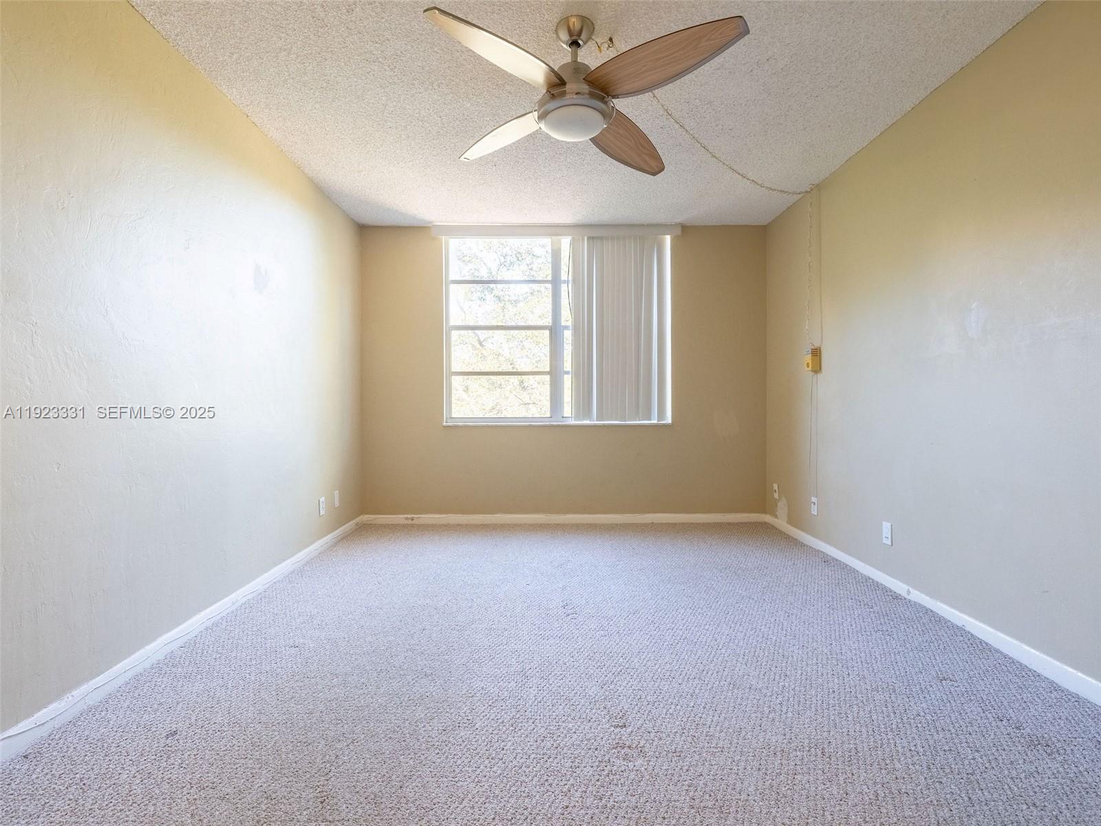 6600 Cypress Road, Unit 406 Plantation, FL 33317 - Photo 16 of 28 an empty room with windows and fan