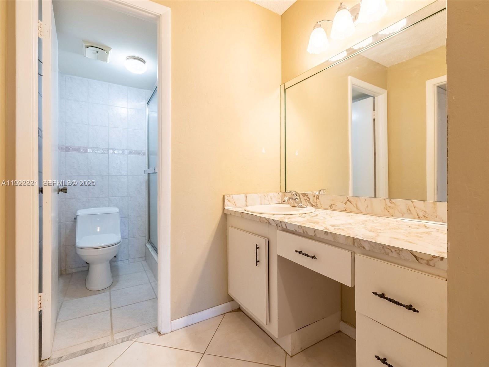 6600 Cypress Road, Unit 406 Plantation, FL 33317 - Photo 17 of 28 a bathroom with a granite countertop sink toilet and shower