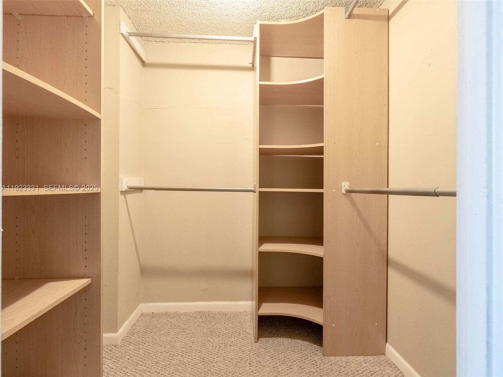6600 Cypress Road, Unit 406 Plantation, FL 33317 - Photo 18 of 28 a view of walk in closet with clothes