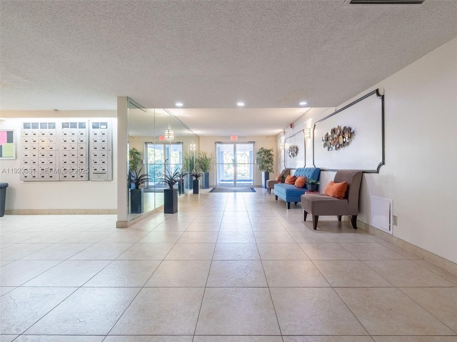 6600 Cypress Road, Unit 406 Plantation, FL 33317 - Photo 22 of 28 a lobby with furniture and rug