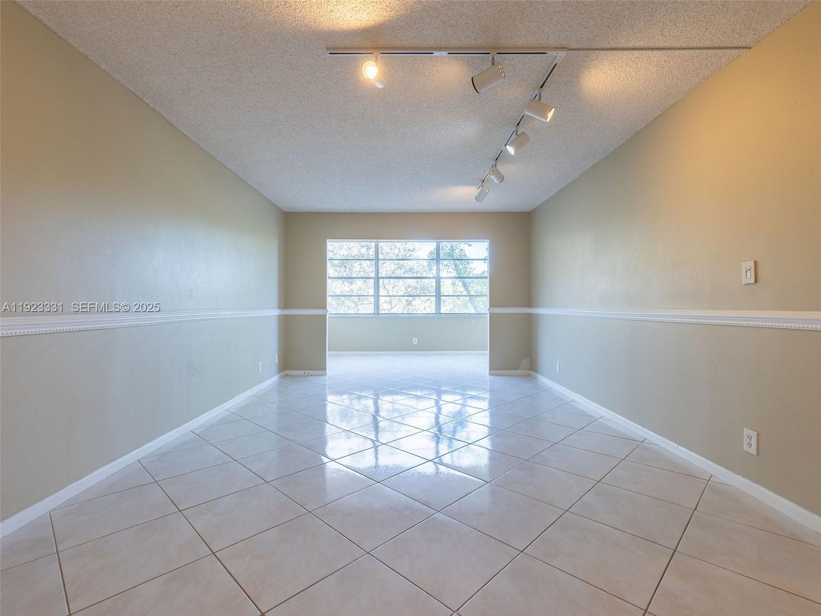 6600 Cypress Road, Unit 406 Plantation, FL 33317 - Photo 3 of 28 a view of an empty room with a window
