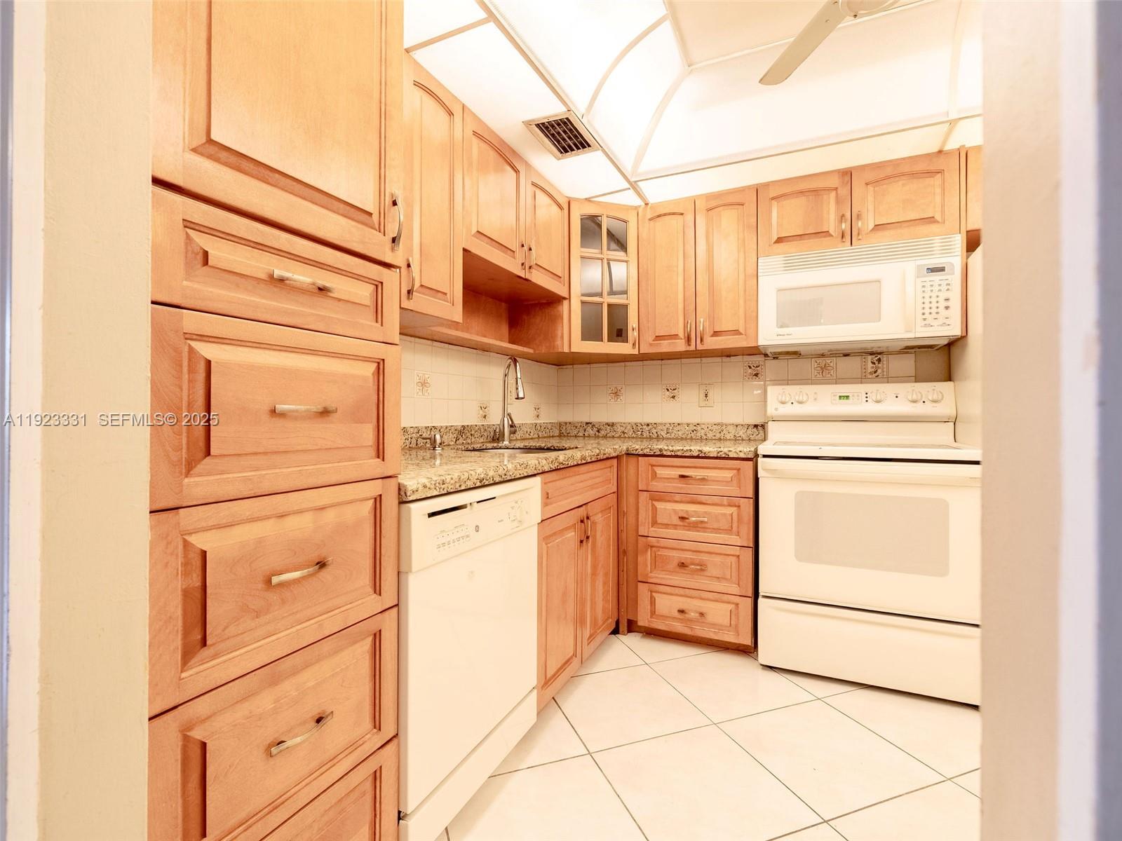 6600 Cypress Road, Unit 406 Plantation, FL 33317 - Photo 4 of 28 a kitchen with cabinets appliances a sink and a window
