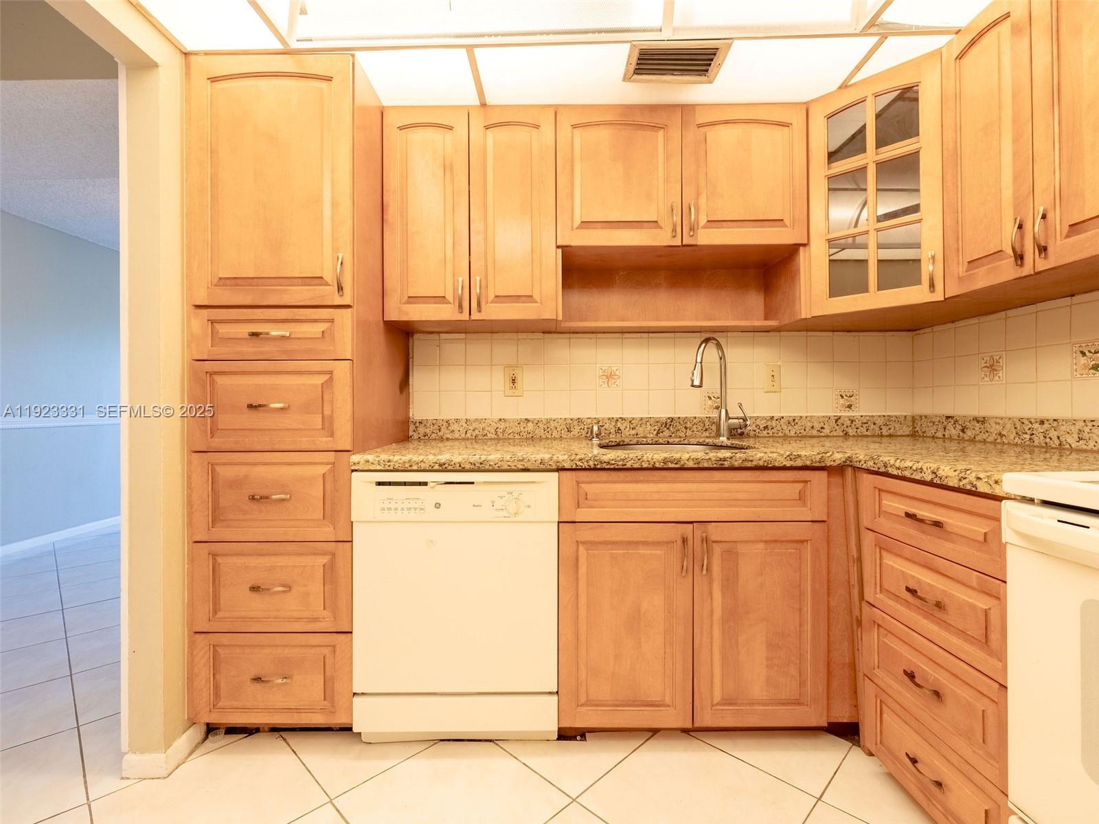 6600 Cypress Road, Unit 406 Plantation, FL 33317 - Photo 6 of 28 a kitchen with stainless steel appliances granite countertop a sink and cabinets