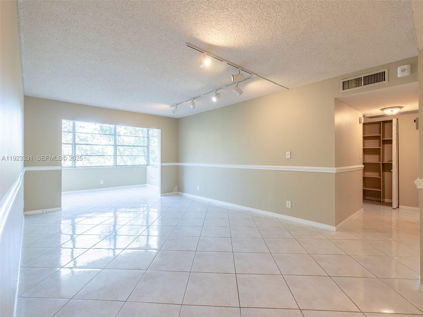 6600 Cypress Road, Unit 406 Plantation, FL 33317 - Photo 7 of 28 a view of an empty room with a window