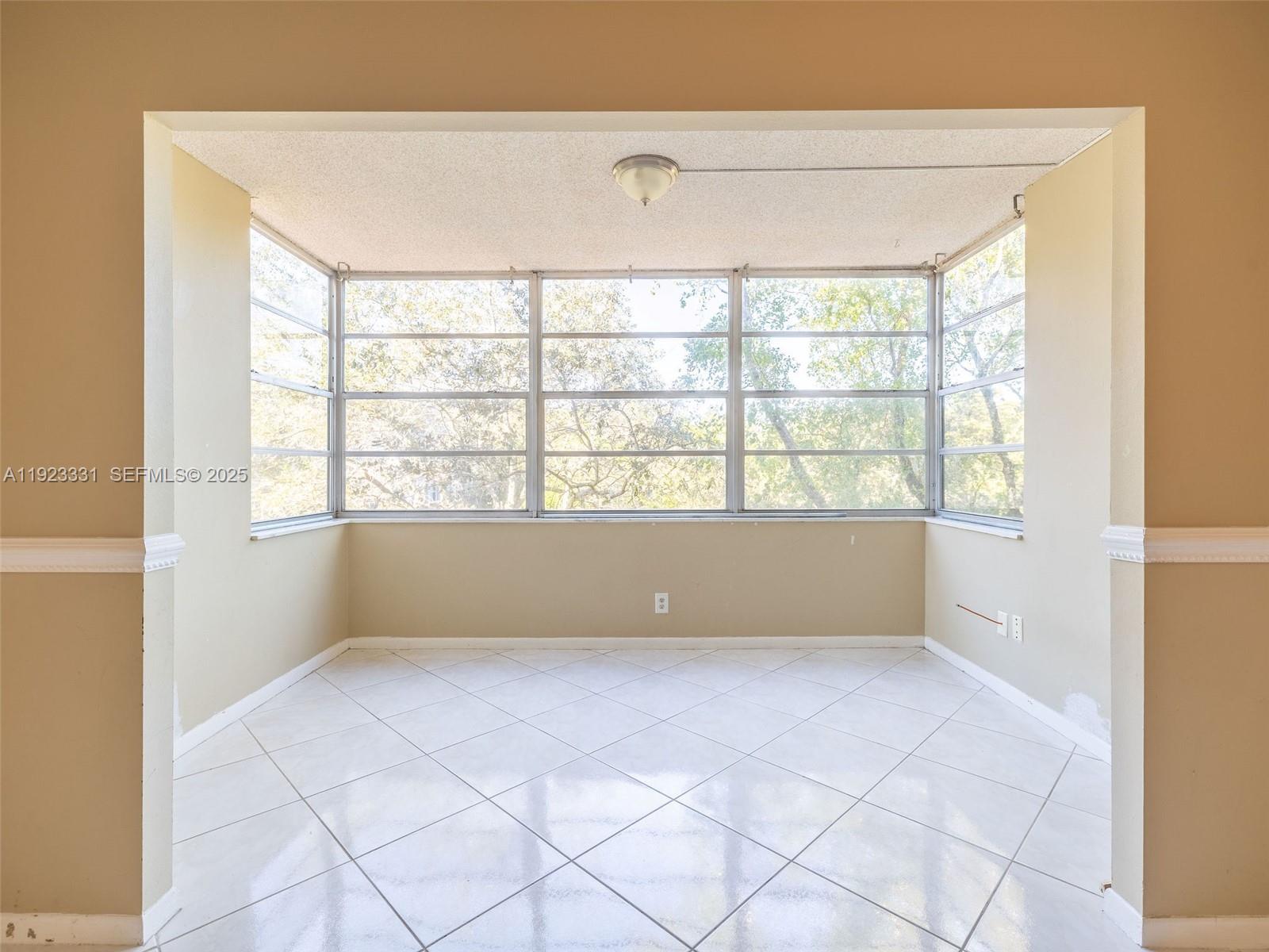 6600 Cypress Road, Unit 406 Plantation, FL 33317 - Photo 8 of 28 a view of an empty room with a window