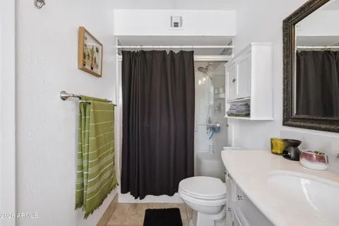 a bathroom with a sink vanity and a mirror