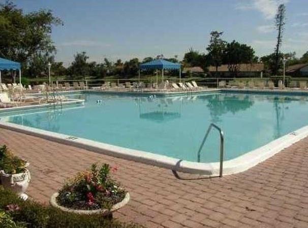 3750 Inverrary Drive, Unit 2K Lauderhill, FL 33319 - Photo 3 of 13 a view of a lake with a yard and large trees