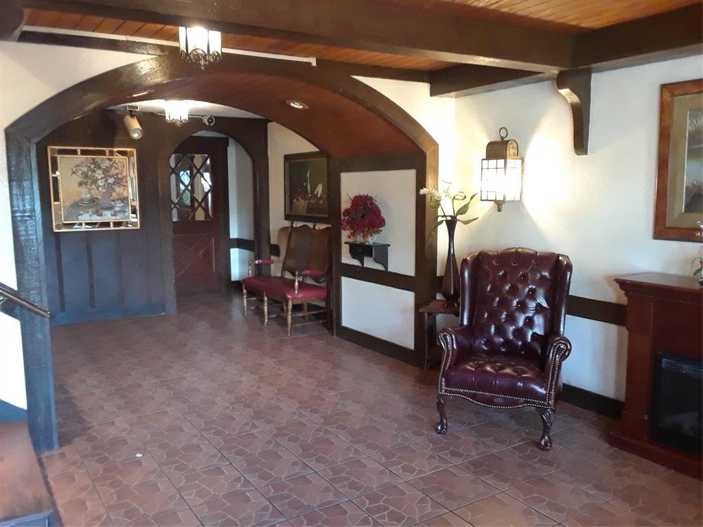 3750 Inverrary Drive, Unit 2K Lauderhill, FL 33319 - Photo 8 of 13 a living room with furniture and a mirror