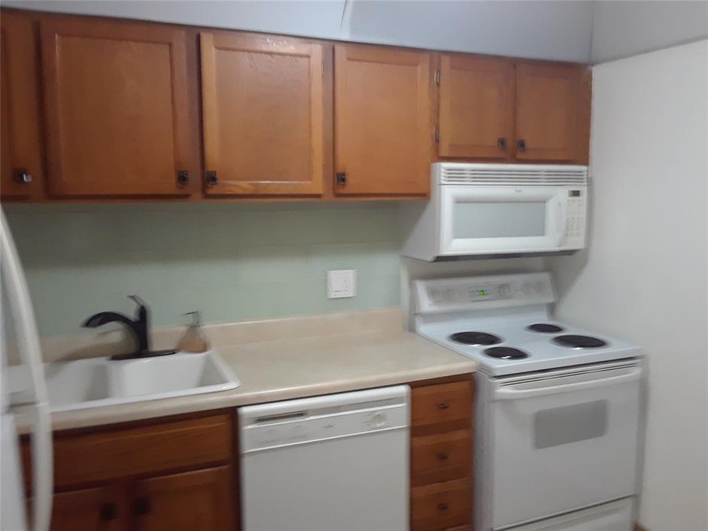 3750 Inverrary Drive, Unit 2K Lauderhill, FL 33319 - Photo 9 of 13 a kitchen with appliances cabinets and a sink