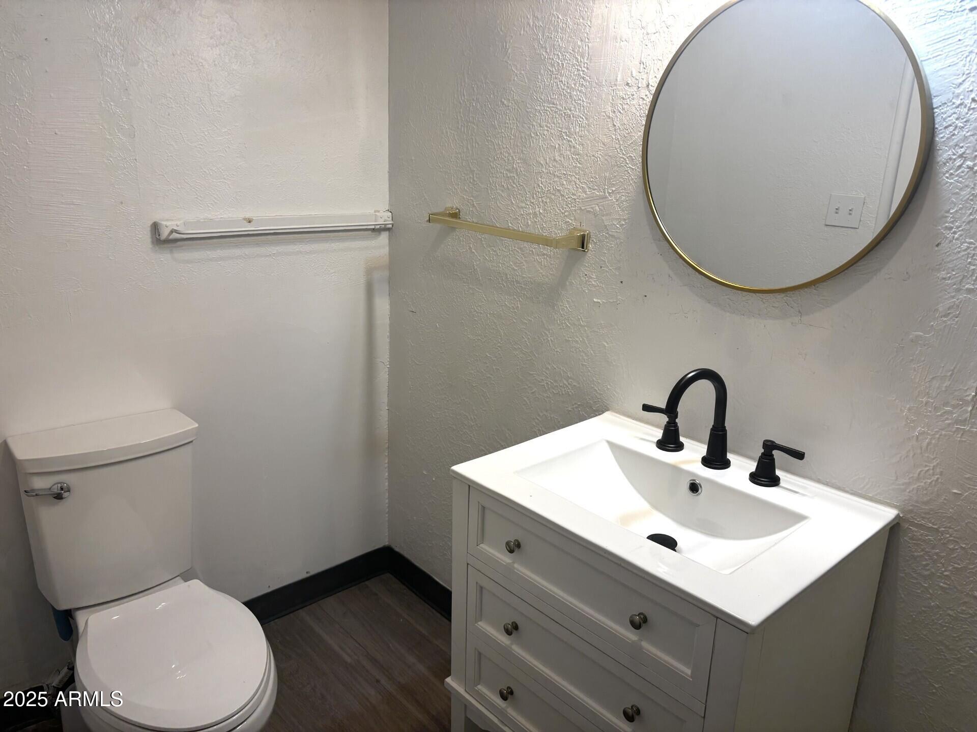 398 E Avenue Douglas, AZ 85607 - Photo 11 of 11 a bathroom with a sink mirror and toilet