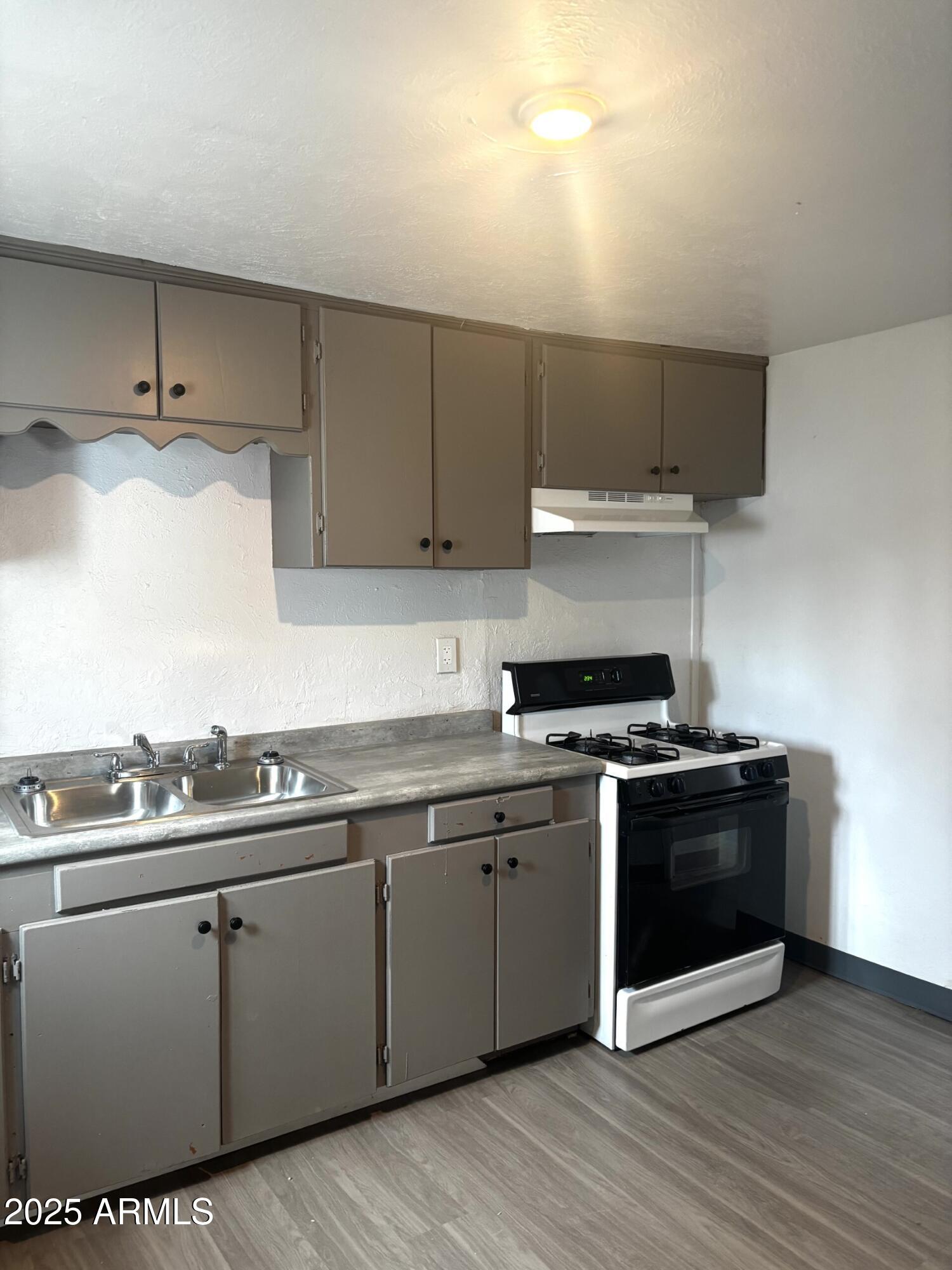398 E Avenue Douglas, AZ 85607 - Photo 2 of 11 a kitchen with stainless steel appliances granite countertop a stove and a sink